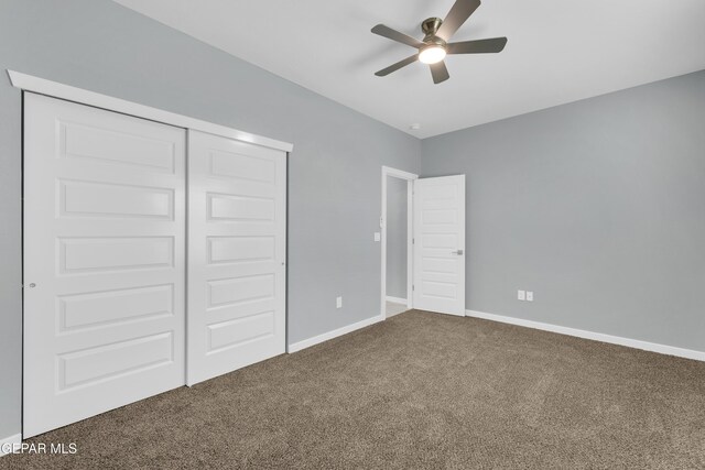 unfurnished bedroom featuring a closet, ceiling fan, and carpet