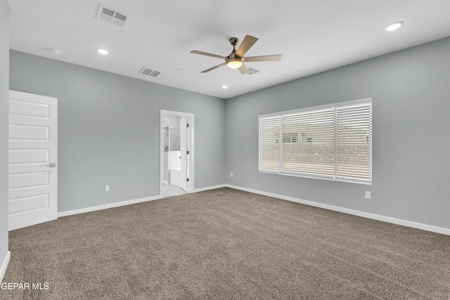 carpeted spare room featuring ceiling fan