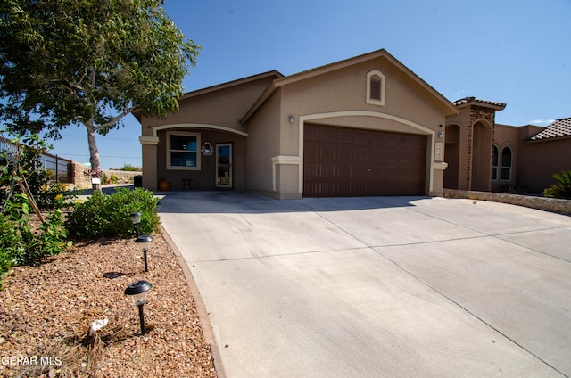 mediterranean / spanish-style home with a garage