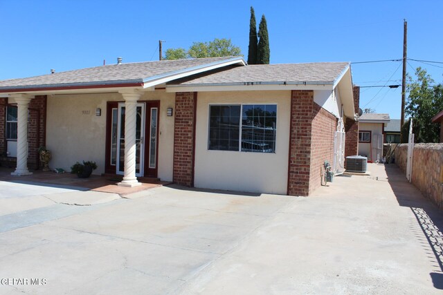 view of front of home featuring cooling unit and a patio area