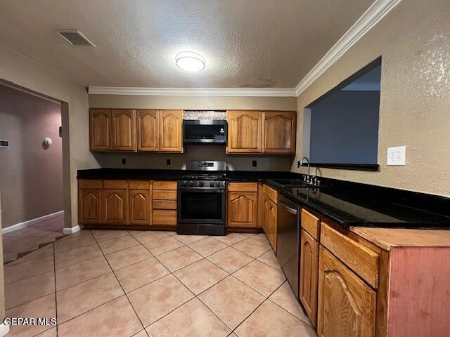 kitchen with light tile patterned flooring, sink, dishwashing machine, crown molding, and stainless steel range with gas stovetop