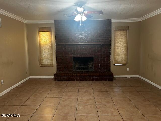 unfurnished living room with crown molding, tile patterned floors, a fireplace, and a textured ceiling