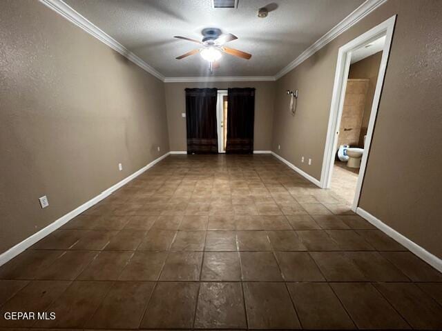 tiled spare room featuring ornamental molding and ceiling fan