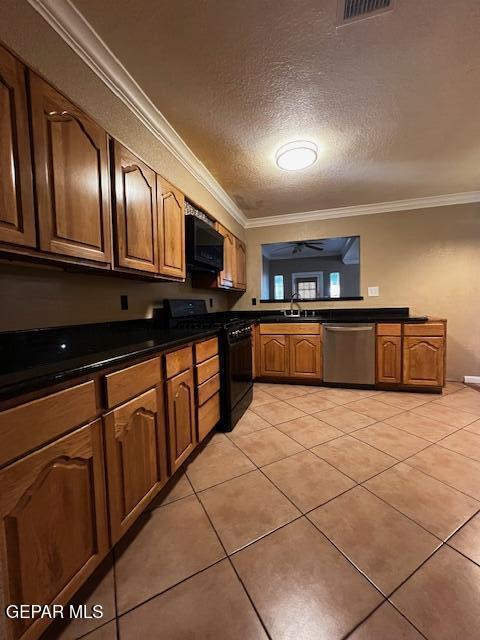 kitchen featuring crown molding, light tile patterned floors, sink, and black appliances