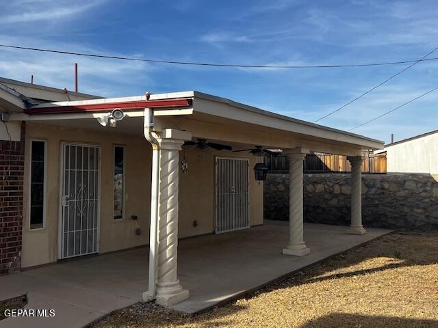 exterior space with ceiling fan