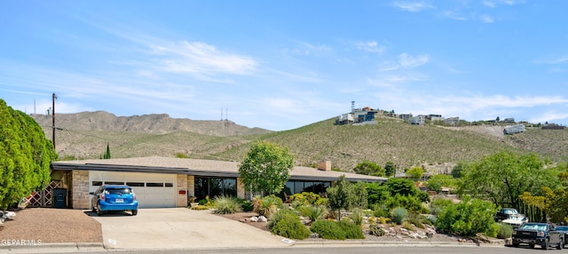 single story home with a mountain view and a garage