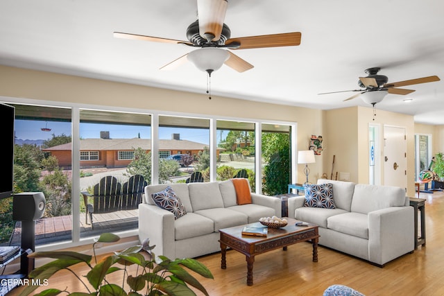 living room featuring light wood-type flooring and ceiling fan