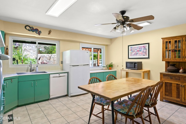 kitchen featuring ceiling fan, plenty of natural light, sink, and white appliances