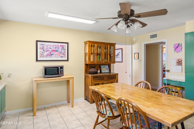 dining area featuring light tile patterned floors and ceiling fan