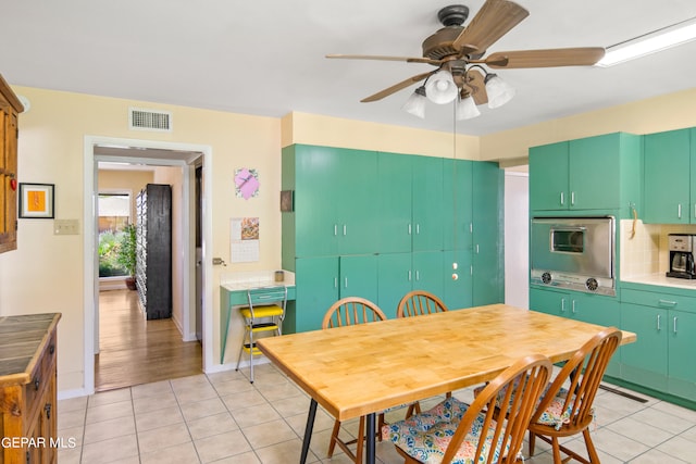 dining room featuring light tile patterned floors and ceiling fan