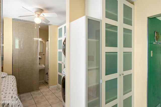 interior space featuring light tile patterned floors and ceiling fan