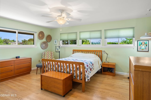 bedroom with light hardwood / wood-style flooring and ceiling fan