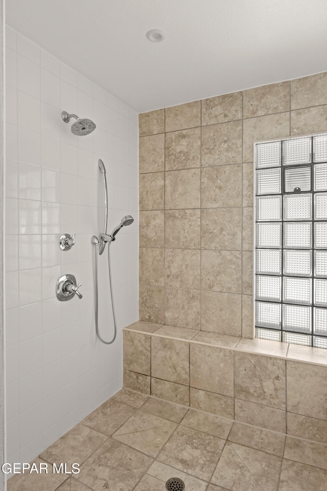 bathroom with tiled shower