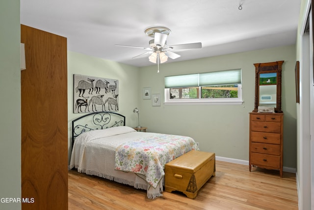 bedroom with light hardwood / wood-style floors and ceiling fan