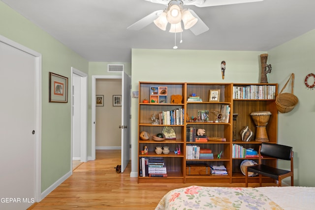 bedroom with ceiling fan and light hardwood / wood-style flooring