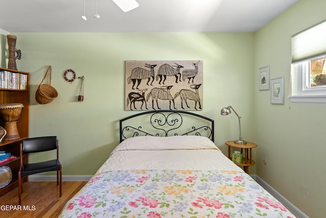 bedroom with hardwood / wood-style floors