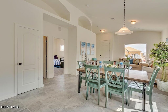 dining room featuring vaulted ceiling