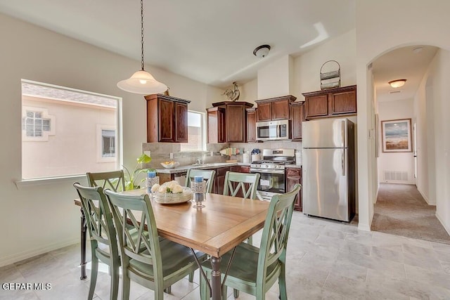 tiled dining area with lofted ceiling