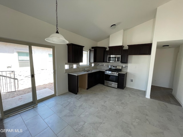 kitchen featuring pendant lighting, dark brown cabinets, sink, high vaulted ceiling, and appliances with stainless steel finishes