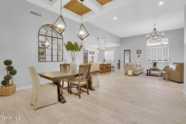 dining space with an inviting chandelier, beamed ceiling, light wood-type flooring, and a towering ceiling