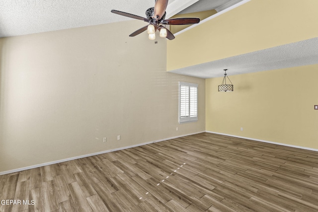 spare room featuring ceiling fan, hardwood / wood-style floors, and a textured ceiling