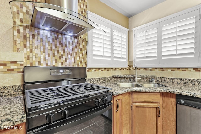 kitchen with light stone countertops, dishwasher, black gas stove, sink, and extractor fan