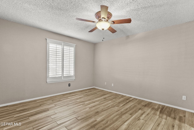 spare room with ceiling fan, a textured ceiling, and light hardwood / wood-style flooring