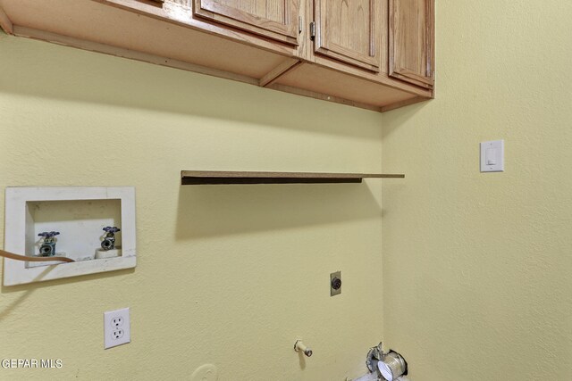 clothes washing area featuring cabinets, electric dryer hookup, washer hookup, and gas dryer hookup