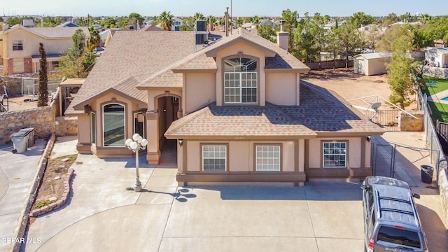 view of front of house with a patio and a shed