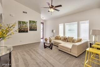 carpeted living room featuring vaulted ceiling, ceiling fan, and a healthy amount of sunlight