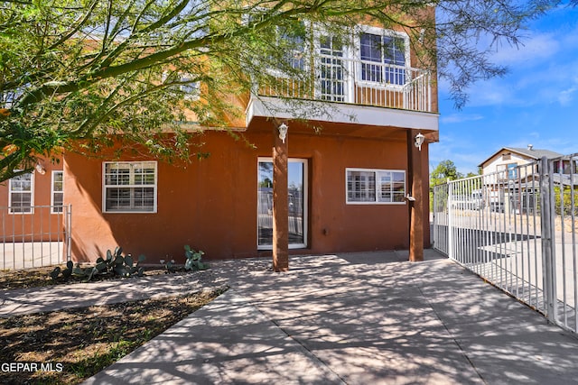 back of property with a patio and a balcony