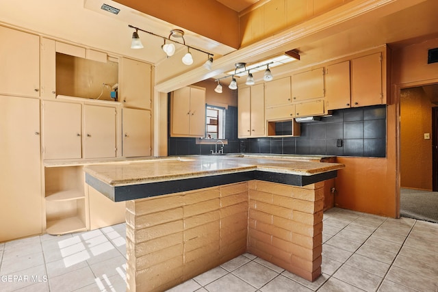 kitchen with a center island, a breakfast bar area, sink, and light tile patterned floors