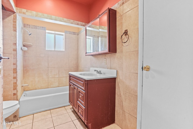 full bathroom featuring tiled shower / bath, vanity, tile patterned flooring, and toilet