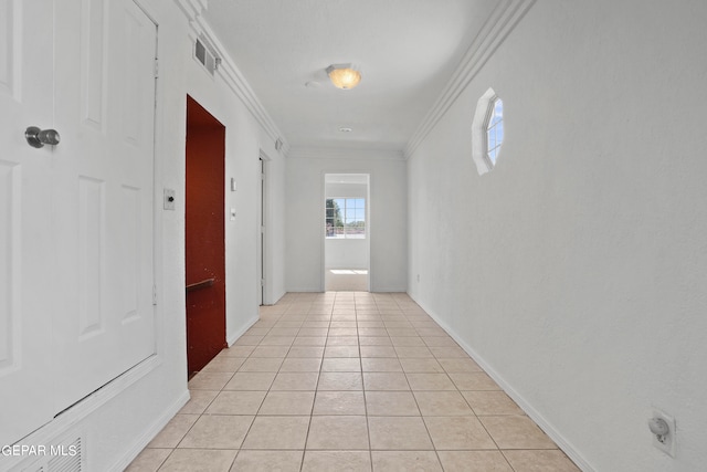 hall with crown molding and light tile patterned floors