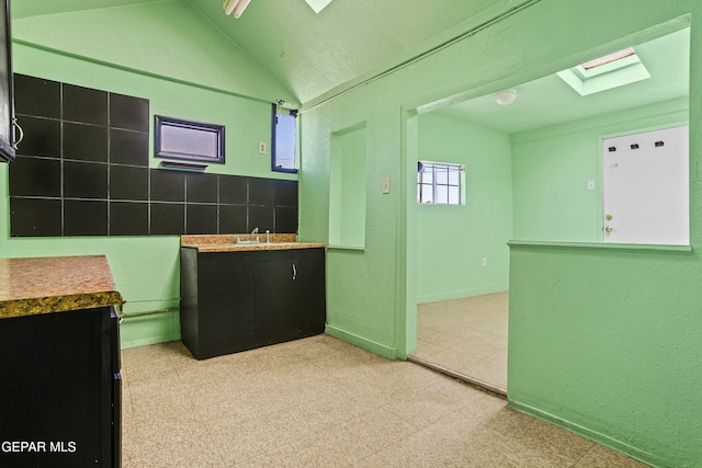 kitchen with lofted ceiling with skylight