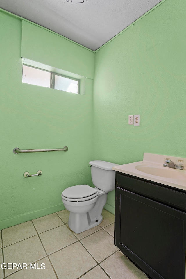 bathroom featuring tile patterned floors, toilet, and vanity