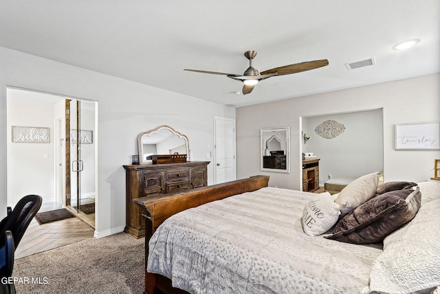 bedroom with ensuite bath, ceiling fan, and parquet floors