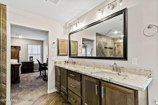 bathroom with a shower and vanity