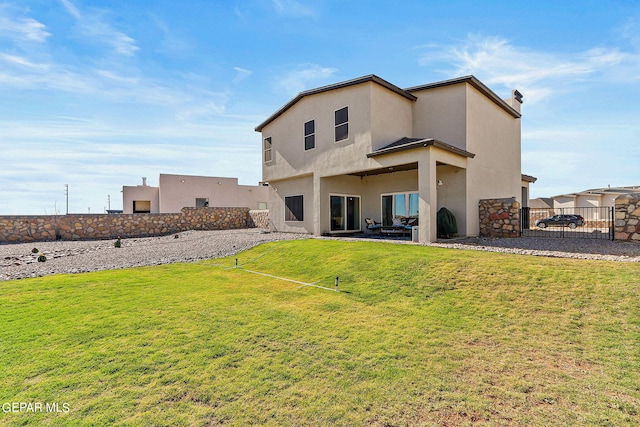 rear view of house featuring a yard and a patio area