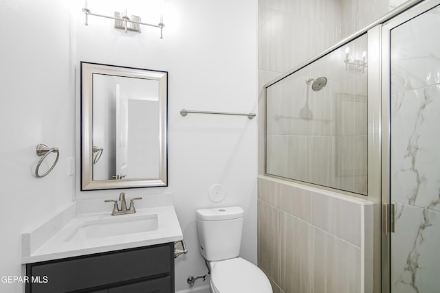 bathroom with walk in shower, vanity, and toilet