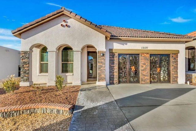 13618 Doncaster St, Horizon City, TX 79928 - view of front of property with a tile roof, stucco siding, and stone siding