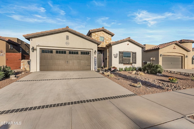 mediterranean / spanish-style house with a garage