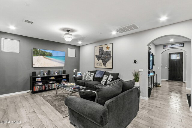 living room featuring light wood-type flooring and ceiling fan