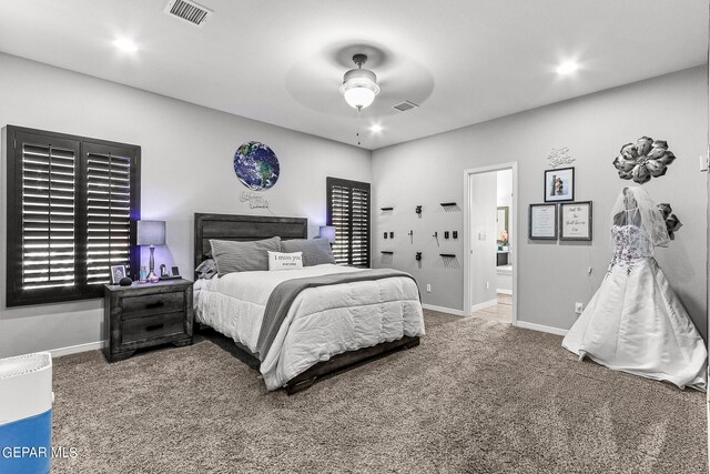 carpeted bedroom featuring ceiling fan and ensuite bath