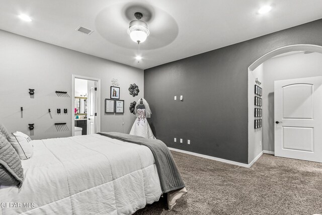 bedroom with carpet floors, ceiling fan, and ensuite bathroom