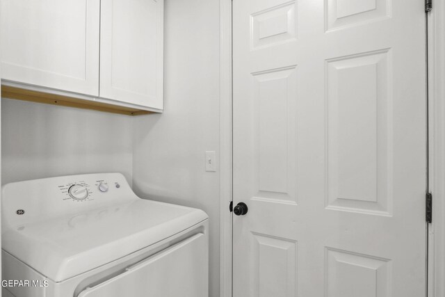 laundry area with cabinets and washer / clothes dryer