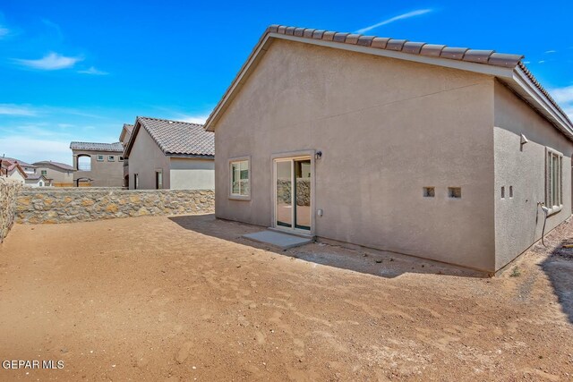 back of house with a patio