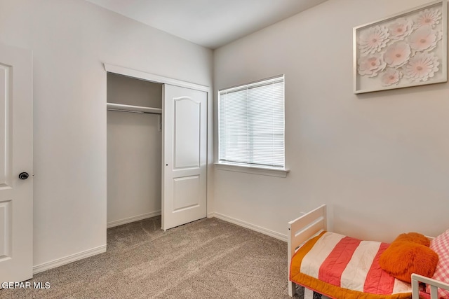 carpeted bedroom with a closet