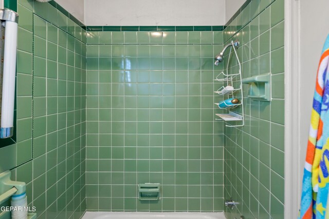 bathroom with shower / bath combo with shower curtain