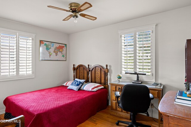 bedroom with ceiling fan and wood-type flooring